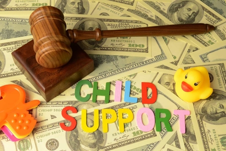 Child Support Spelled Out with Money, Gavel & Toys